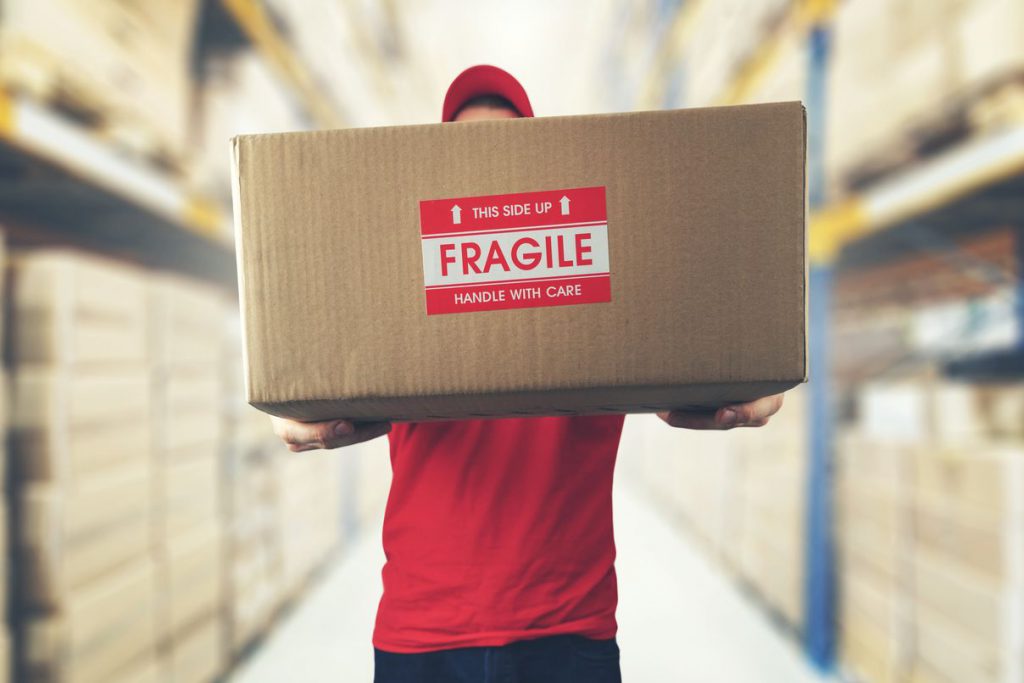 One of the Chicago movers, holding a package labeled as fragile
